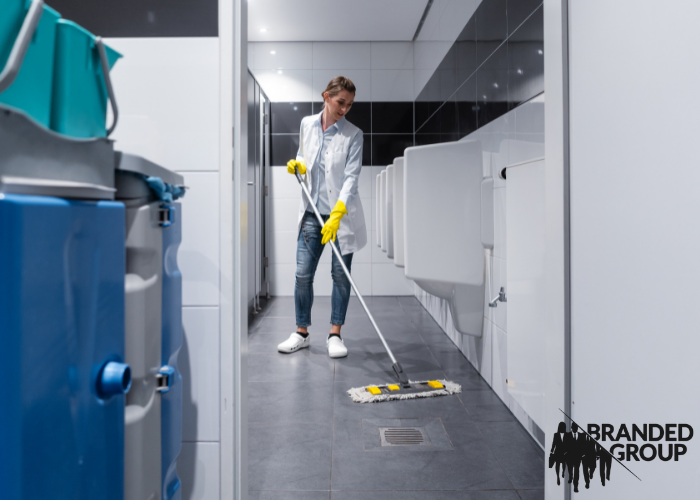 Commercial janitorial service cleaning bathroom.